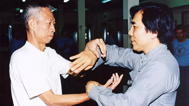 Grandmaster Jim Fung (right) practises Chi Sau with Chu Shong Tin (left).