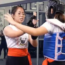 A female Wing Chun instructor demonstrates a technique