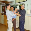 Instructor Tristan Fung practises Chi Sau with Sigung Chu Shong Tin while his father, Grandmaster Jim Fung, watches in Hong Kong, 2003.