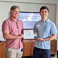 Senior Instructor Tristan Fung receives a certificate of thanks from Professor Corey Smith for the Memorial Fund's donation to cancer research at QIMR Berghofer in Brisbane, 2022.